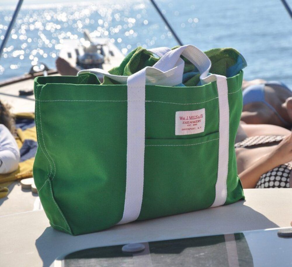A green canvas tote on a sail boat.