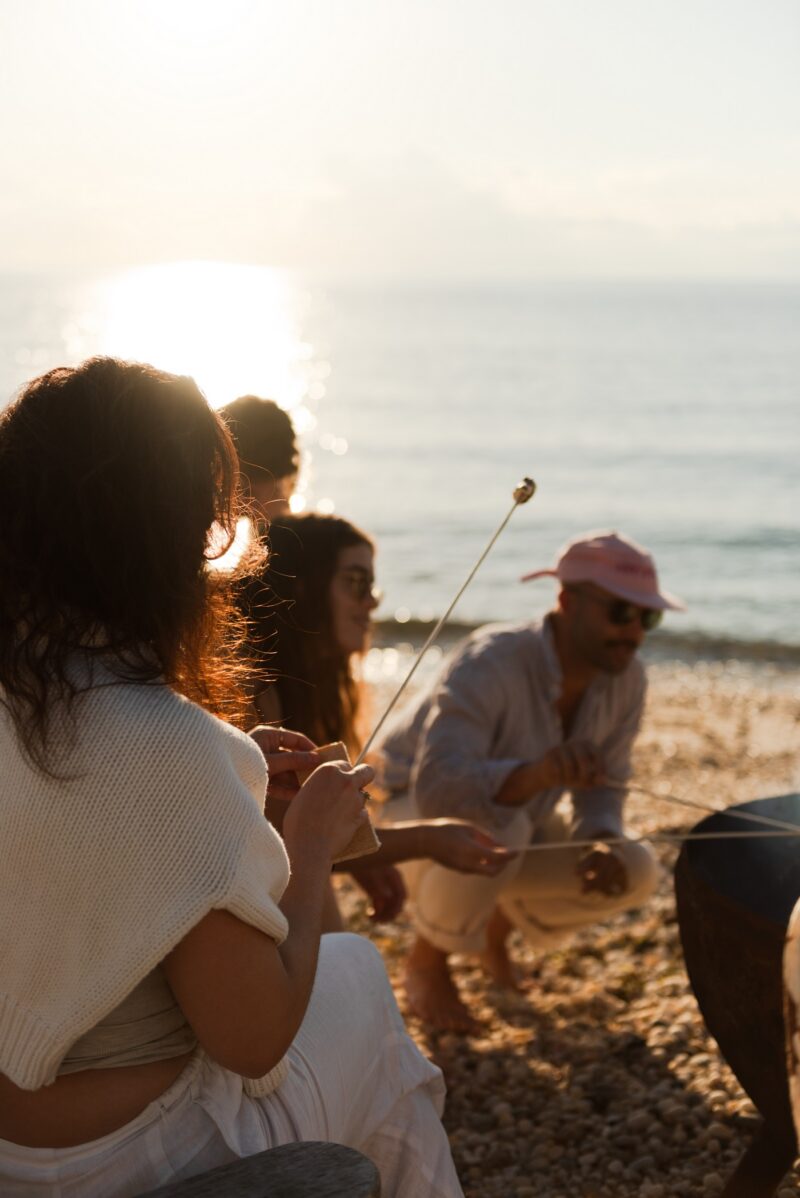 Friends having s'mores by the beach.