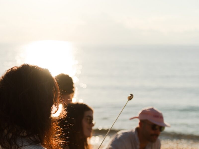 Friends having s'mores by the beach.