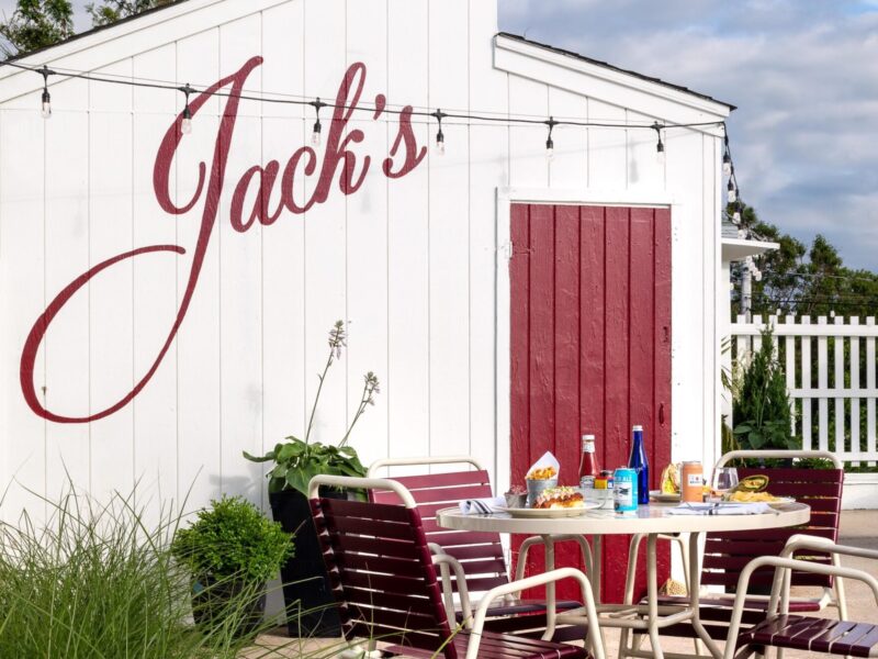 A patio table and chairs next to Jack's Shack.