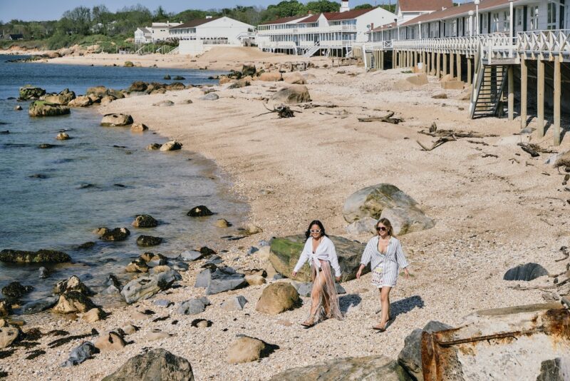 Two friends walking down the beach at Sound View Greenport.