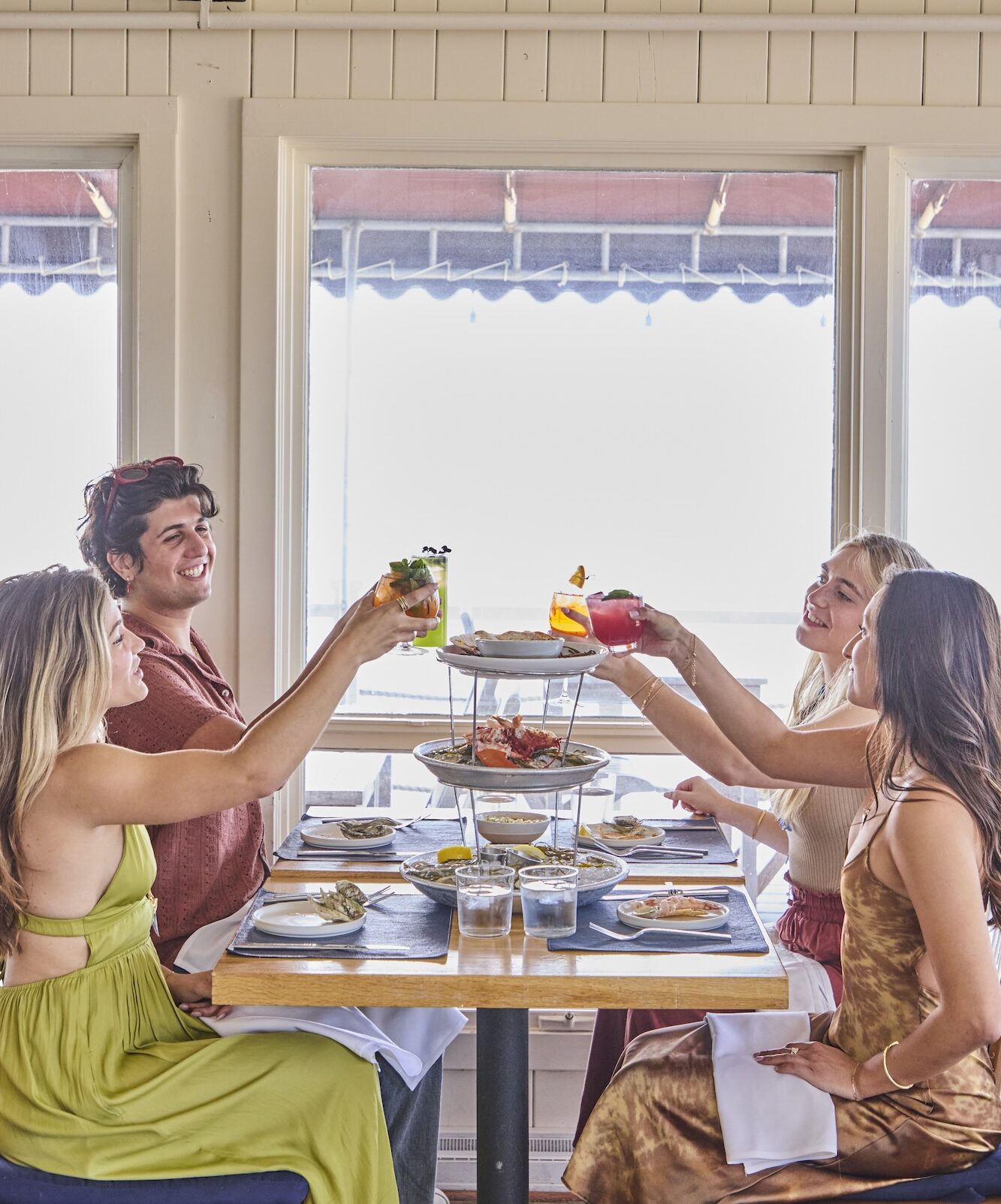 Friends toasting cocktails at The Halyard.