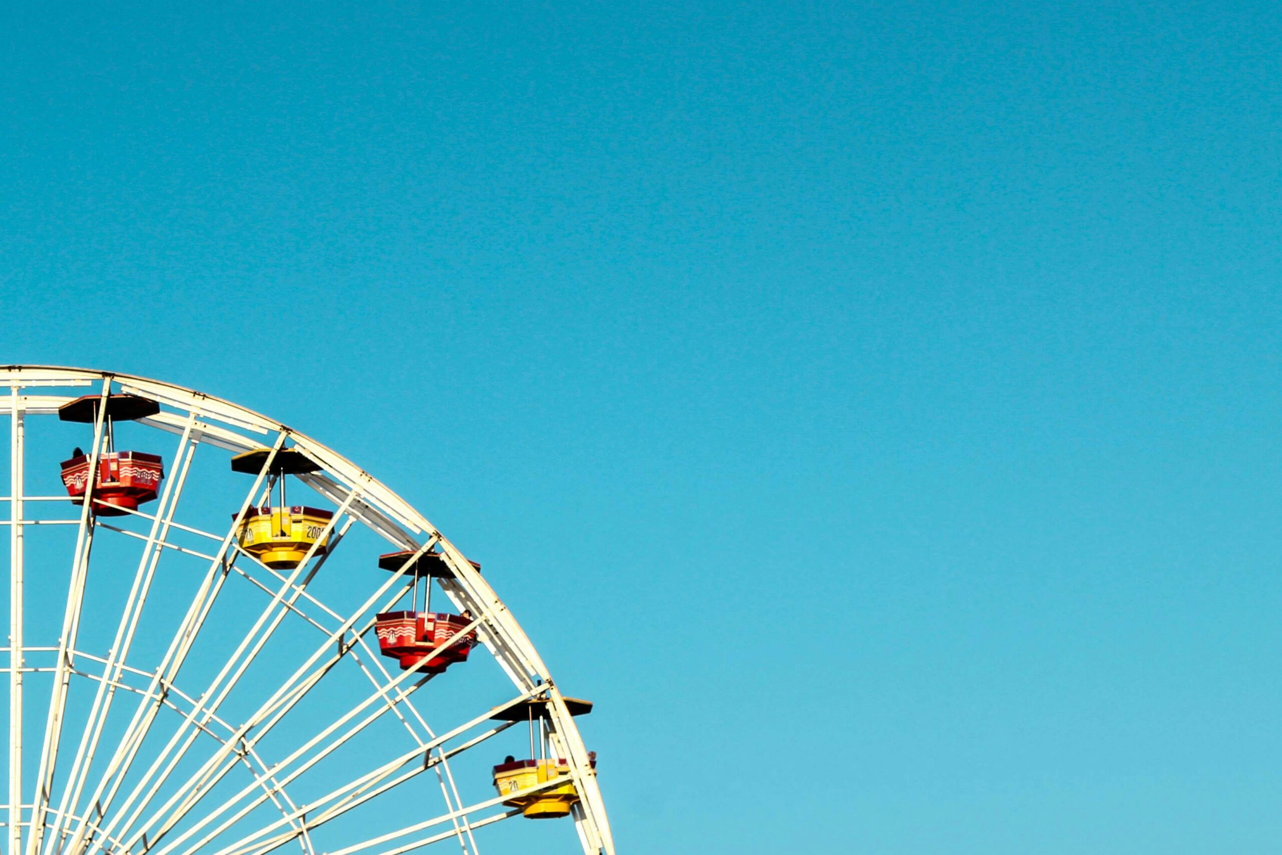 A ferris wheel with blue skies in the background.