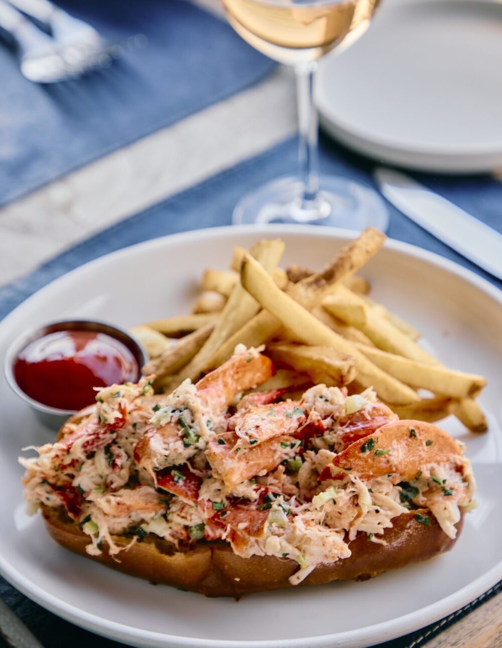 A lobster roll, fries and glass of rosé at The Halyard Restaurant.