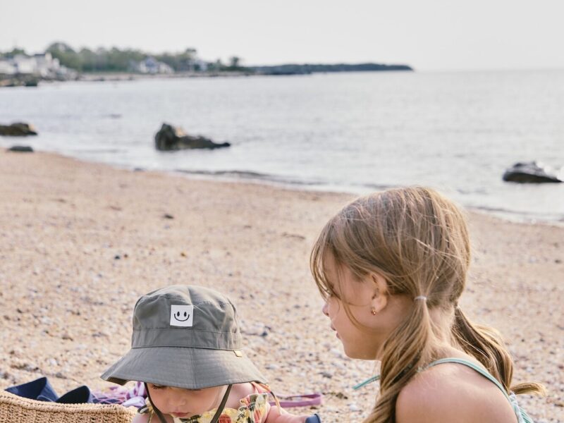 Two young kids playing on a beach.