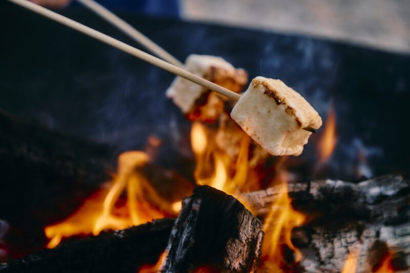 Marshmallows being toasted by the fire.