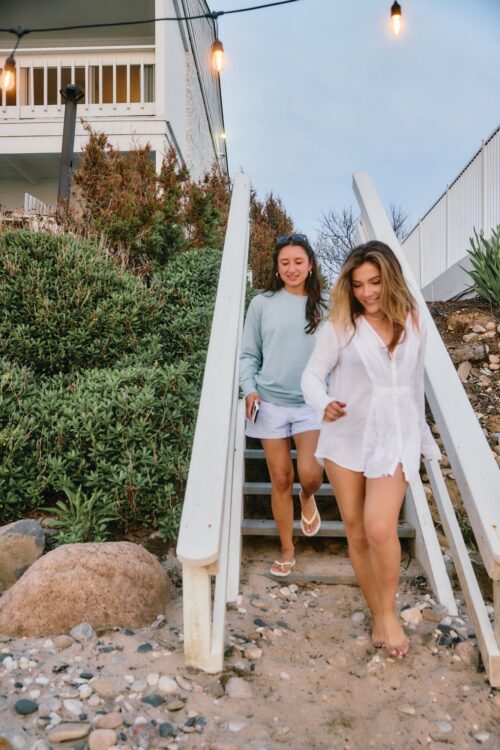 Two women walking down to the beach.
