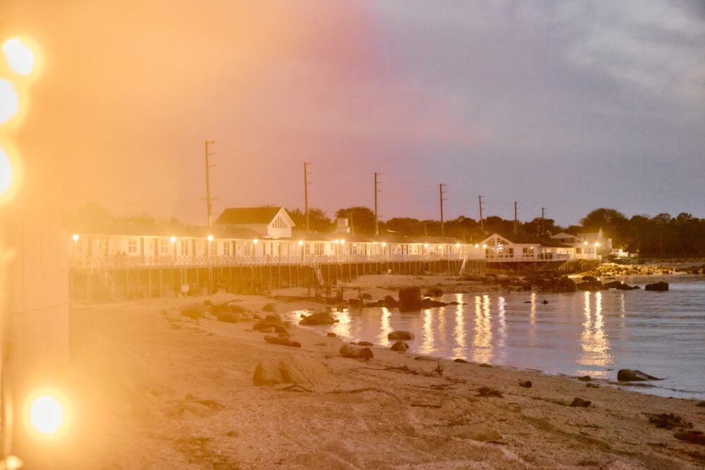 Twinkling lights at dusk with a view of Sound View Greenport and the beach.