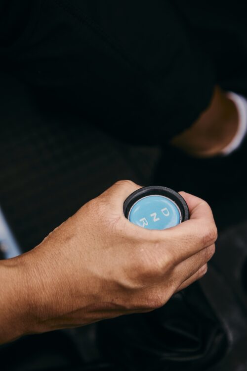 A woman's hand on the gear shift in the Moke.