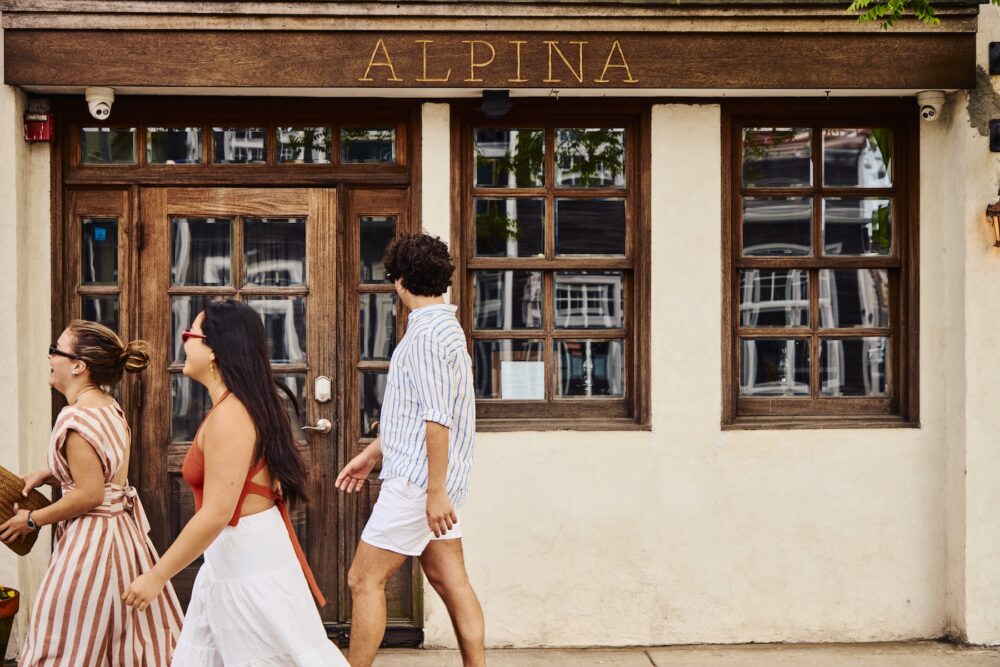 A group of people walking through Greenport Village in New York.