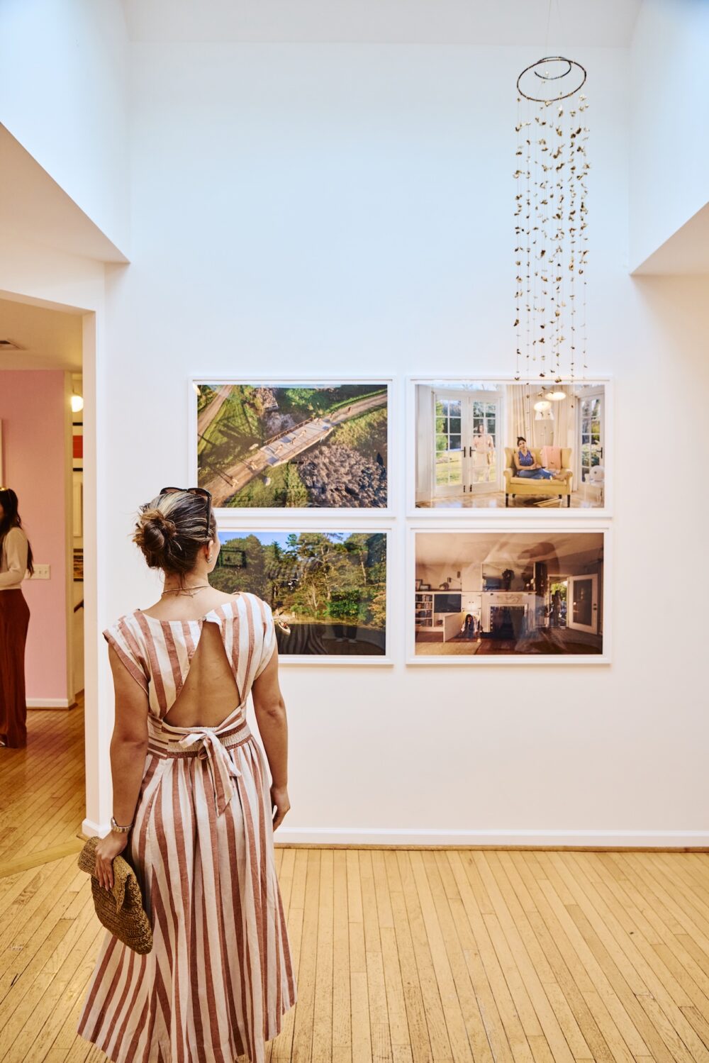 A woman looking at artwork in a gallery.