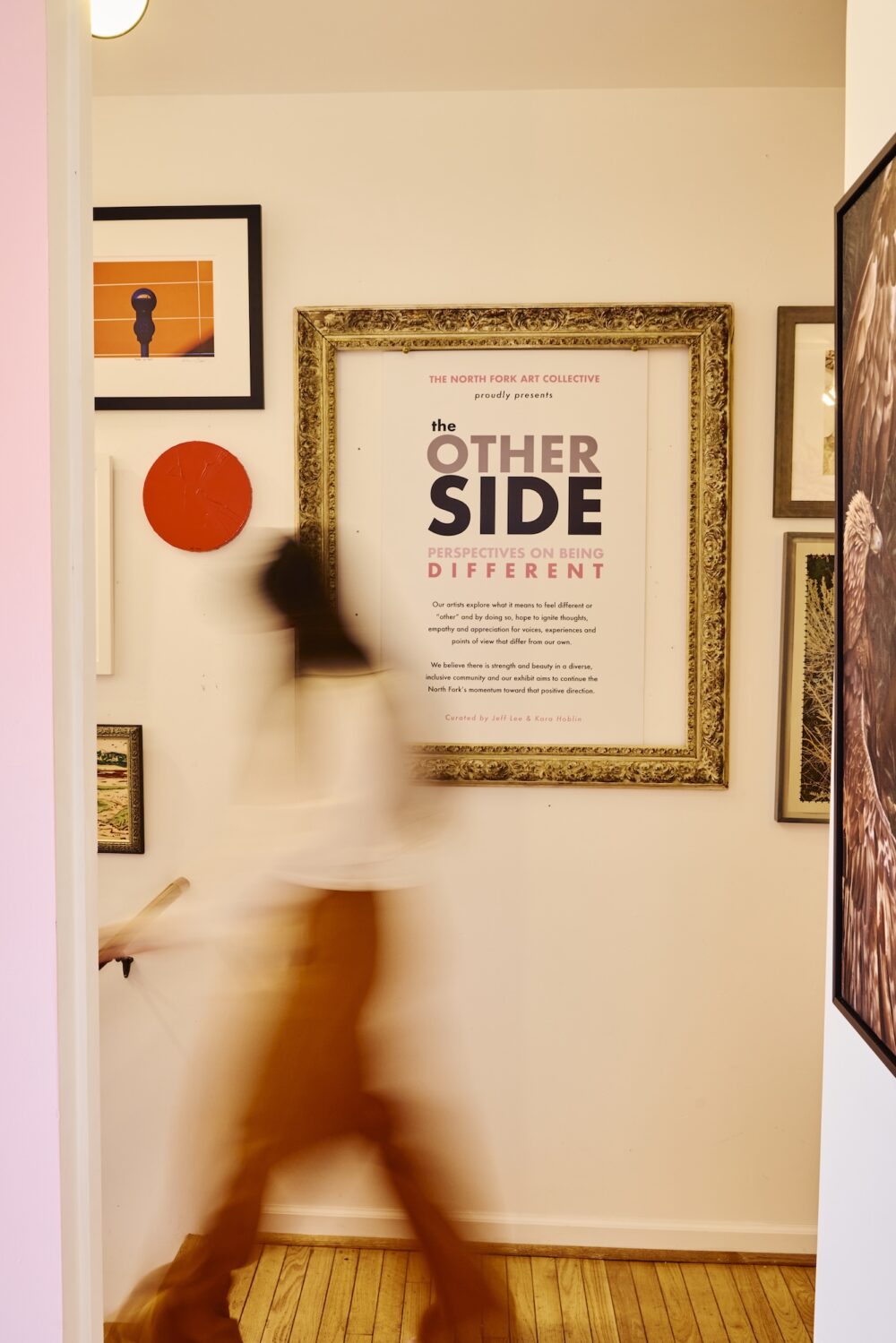 A woman walking through a gallery in North Fork.