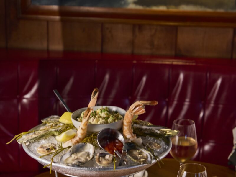 A seafood tower and glasses of white wine.