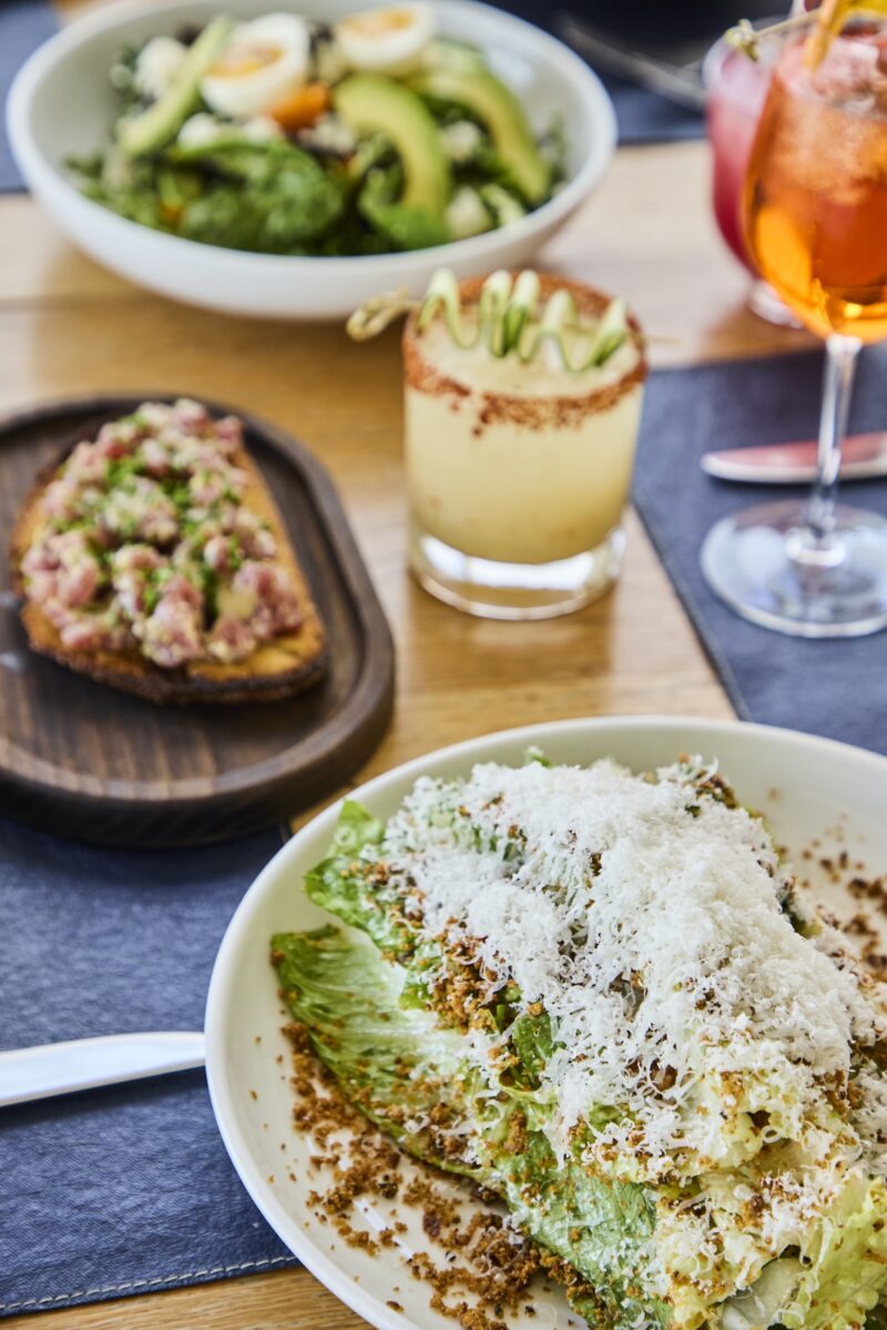 A Caesar salad, tuna tartare, and assorted cocktails at The Halyard.