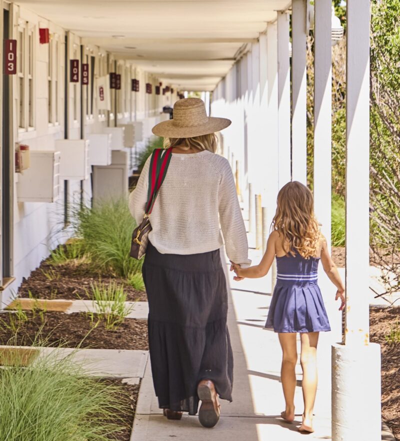 A mother and daughter walking by the guest rooms at Sound View Greenport.