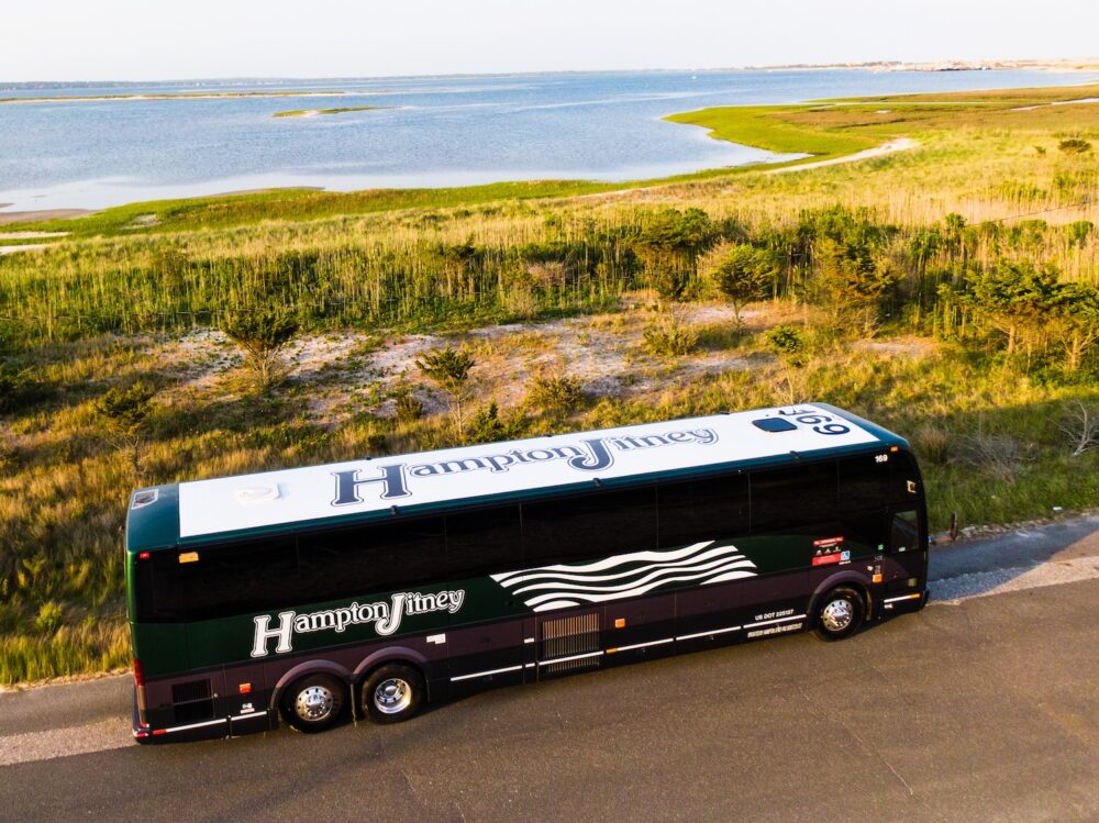 The Hampton Jitney driving along the water on Long Island.