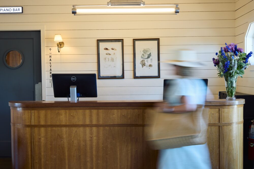 A woman walking through the lobby of Sound View Greenport.