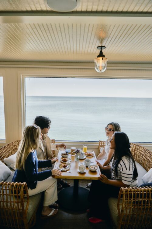 A group of people having breakfast in the lounge at Sound View Greenport.