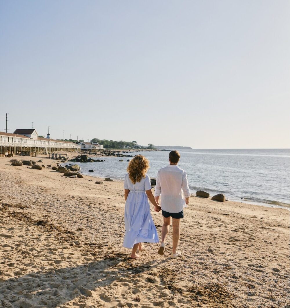 A couple walking along the beach.