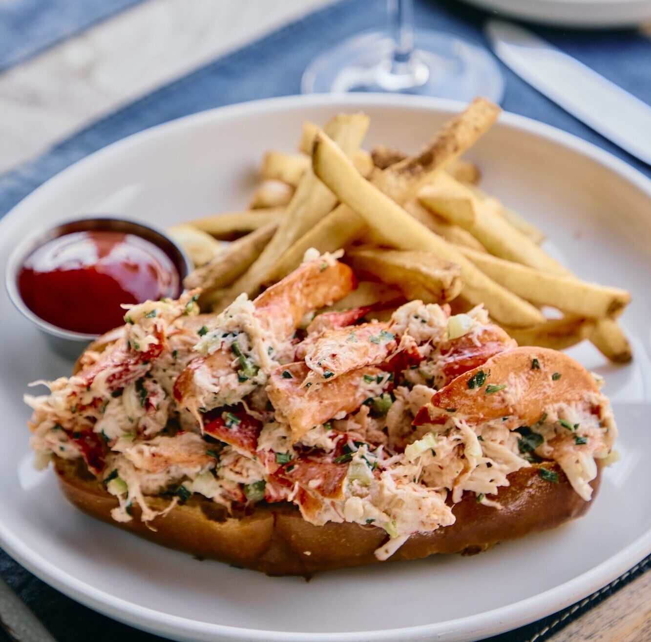 A lobster roll, fries and glass of rosé at The Halyard Restaurant.