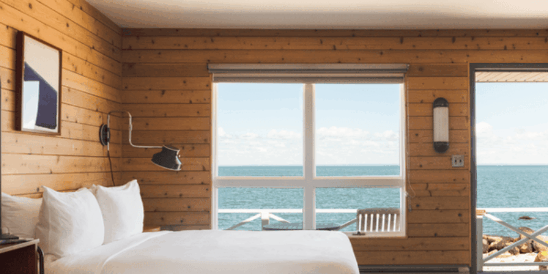 a hotel bed with ocean view